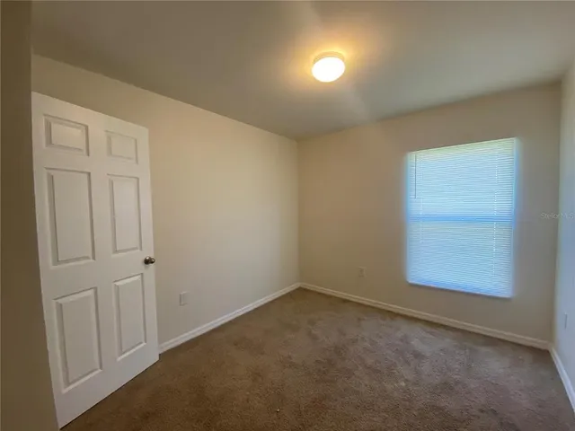 a kitchen with a refrigerator and a stove