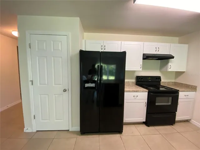 a kitchen with cabinets appliances and a sink