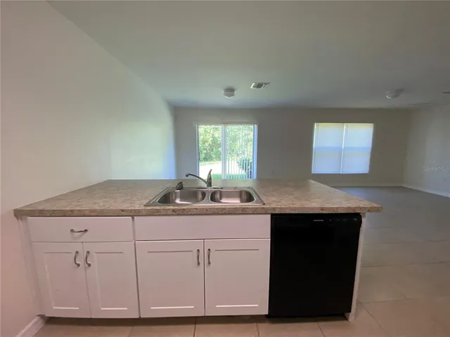 an empty room with a empty space and windows