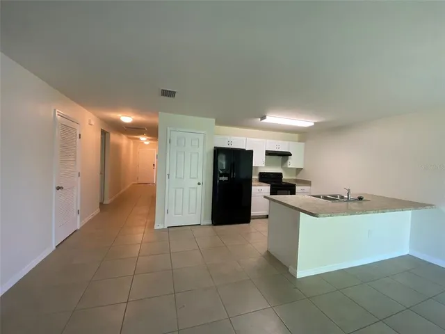 a kitchen with kitchen island cabinets and refrigerator