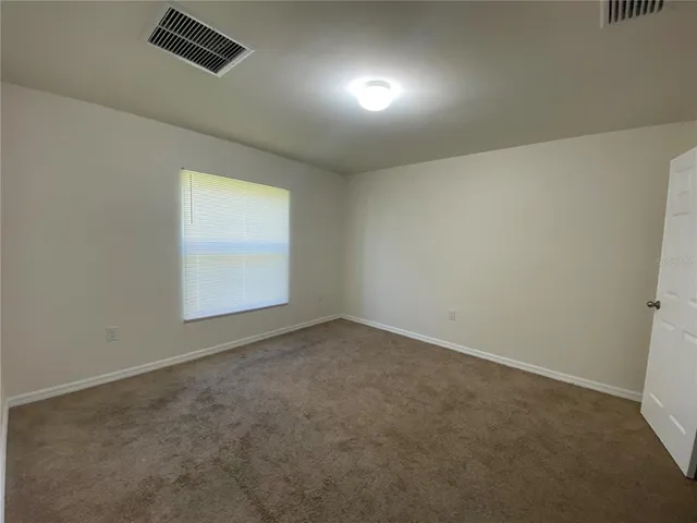 an empty room with a empty space and a window