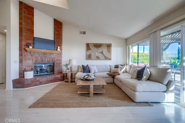 a kitchen with stainless steel appliances kitchen island granite countertop a refrigerator and a stove top oven