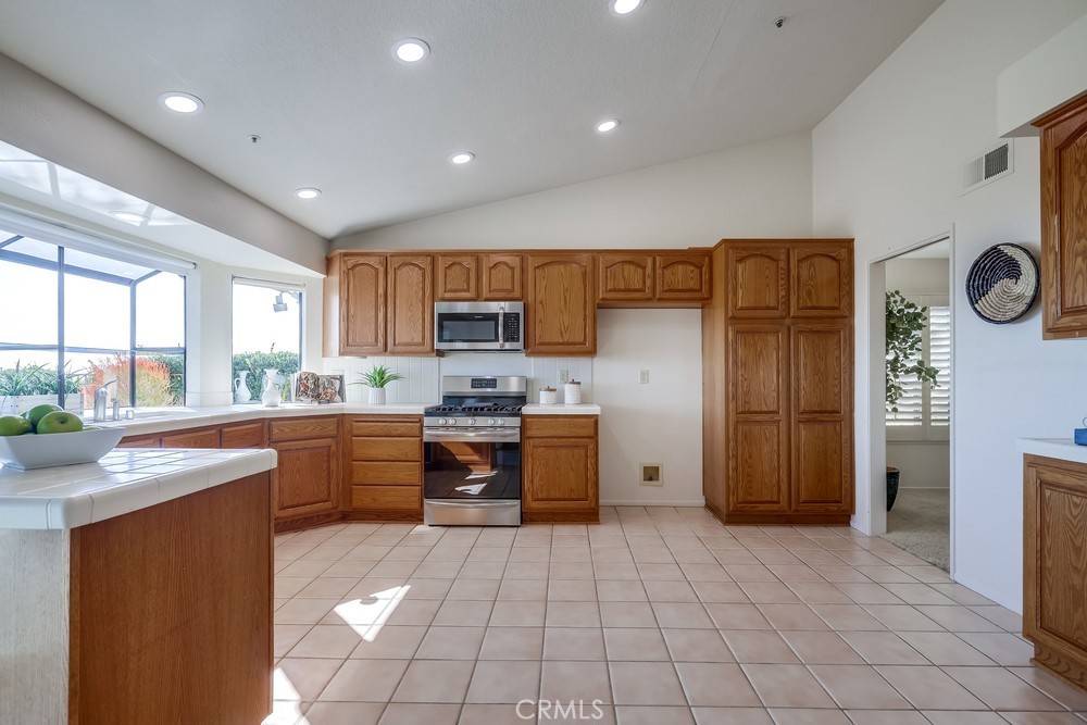 2945 Via Blanco San Clemente, CA 92673 - Photo 26 of 60 a kitchen with granite countertop a refrigerator and a stove top oven
