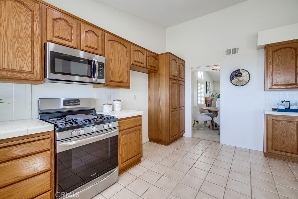 2945 Via Blanco San Clemente, CA 92673 - Photo 27 of 60 a kitchen with stainless steel appliances granite countertop a stove and a microwave