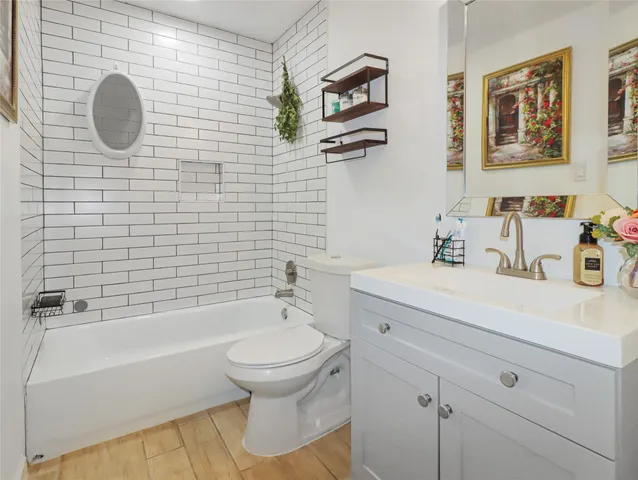 a bathroom with a sink mirror bathtub and toilet