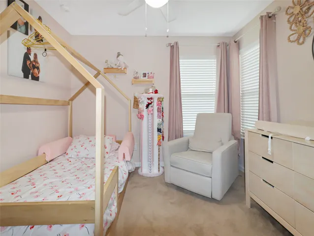 a living room with furniture and a dresser