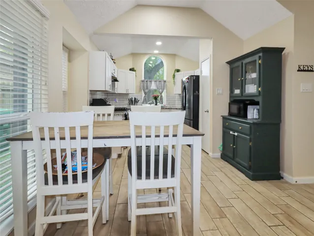 a kitchen with stainless steel appliances kitchen island granite countertop a refrigerator and cabinets