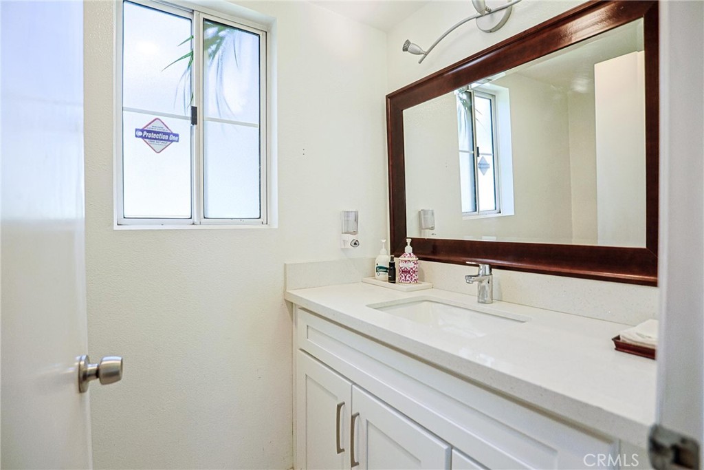 13079 Winterpark Way Riverside, CA 92503 - Photo 18 of 33 a bathroom with a sink and a mirror