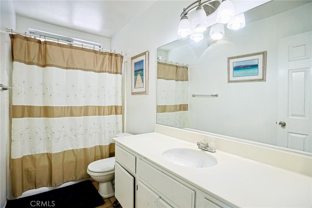 13079 Winterpark Way Riverside, CA 92503 - Photo 21 of 33 a bathroom with a sink a toilet and shower