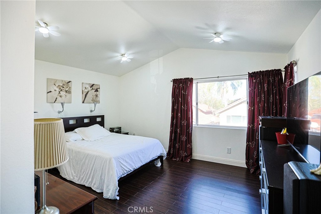 13079 Winterpark Way Riverside, CA 92503 - Photo 22 of 33 a bedroom with a bed and wooden floor