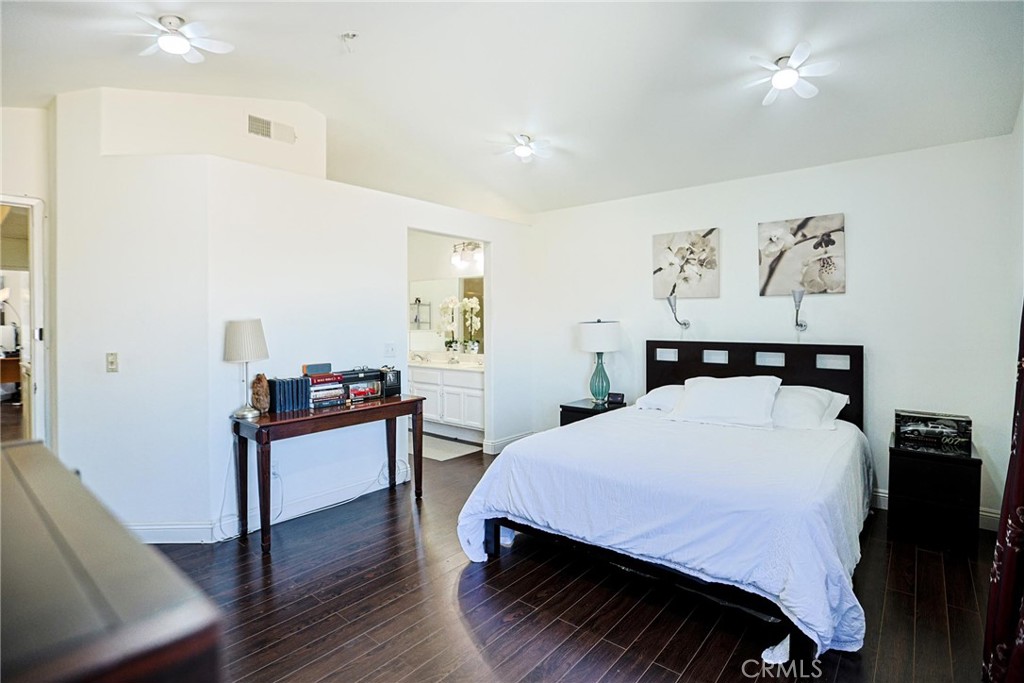 13079 Winterpark Way Riverside, CA 92503 - Photo 23 of 33 a bedroom with a bed and a table in it