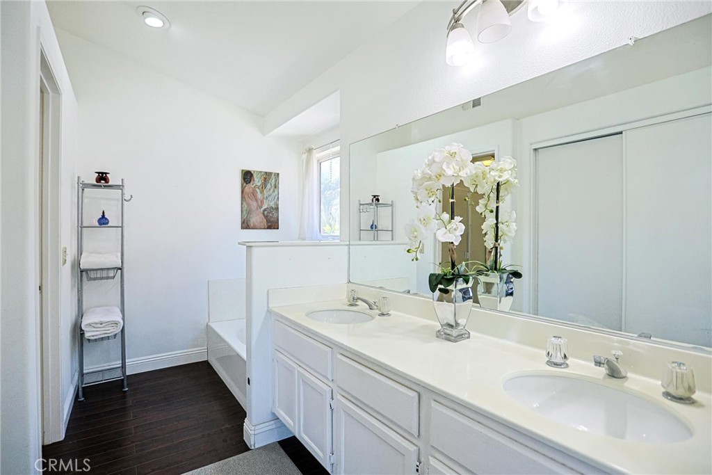 13079 Winterpark Way Riverside, CA 92503 - Photo 25 of 33 a bathroom with a double vanity sink and a mirror