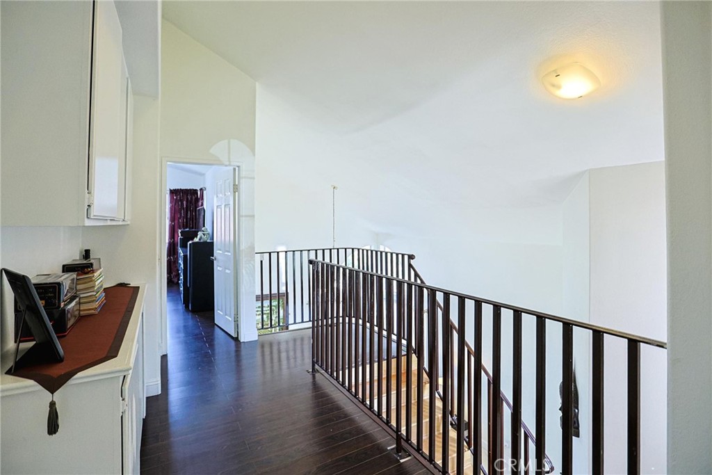 13079 Winterpark Way Riverside, CA 92503 - Photo 28 of 33 a view of a hallway with wooden floor and a potted plant