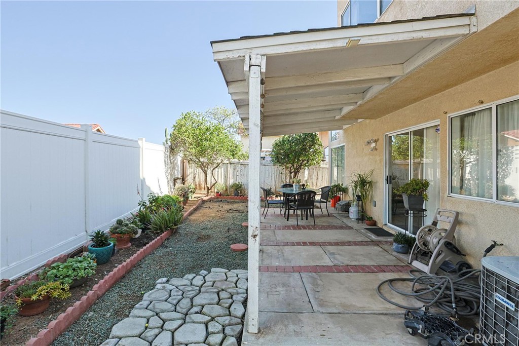 13079 Winterpark Way Riverside, CA 92503 - Photo 29 of 33 a view of a patio with table and chairs potted plants
