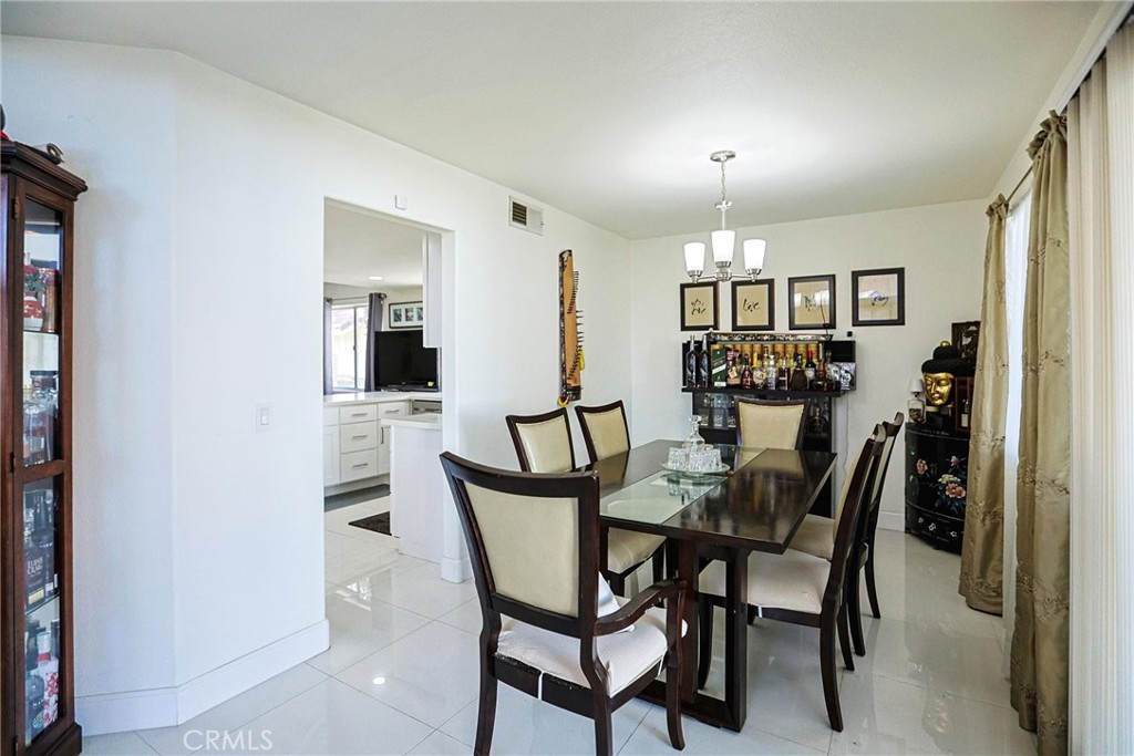 13079 Winterpark Way Riverside, CA 92503 - Photo 9 of 33 a view of a dining room with furniture and chandelier