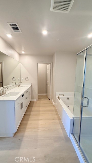 2112 Rio Grande Pomona, CA 91766 - Photo 6 of 10 a large white bathroom with a double vanity sink a mirror and a bathtub