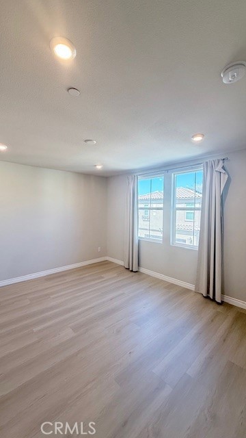 2112 Rio Grande Pomona, CA 91766 - Photo 7 of 10 an empty room with wooden floor and windows