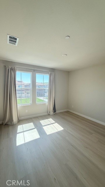 2112 Rio Grande Pomona, CA 91766 - Photo 8 of 10 an empty room with wooden floor and windows