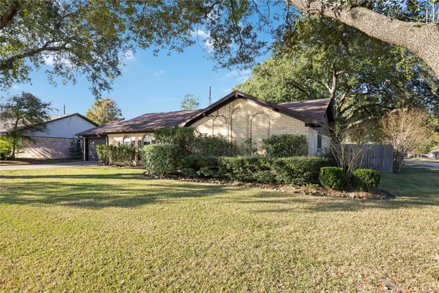 a view of a house with a yard and sitting area
