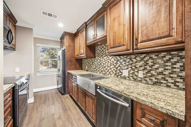a kitchen with a stove a sink and a refrigerator