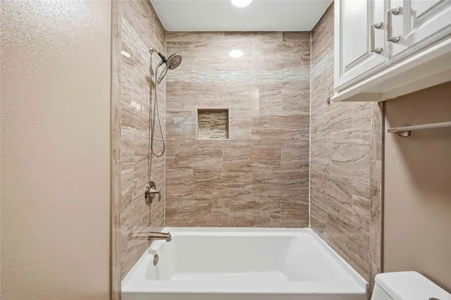 a bathroom with a bathtub and shower