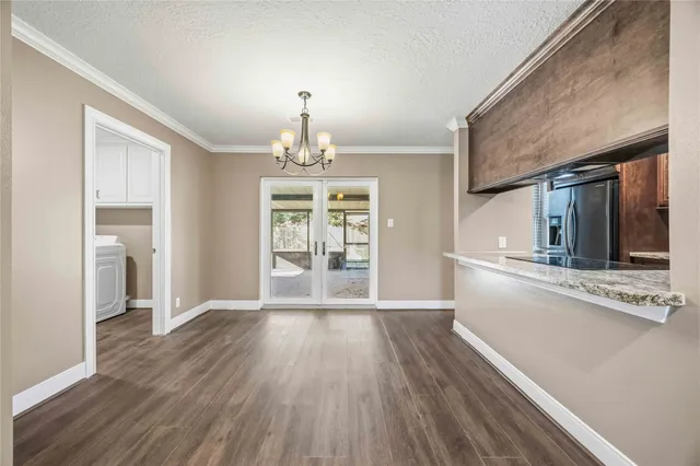 a view of a kitchen with a sink a refrigerator and wooden floor