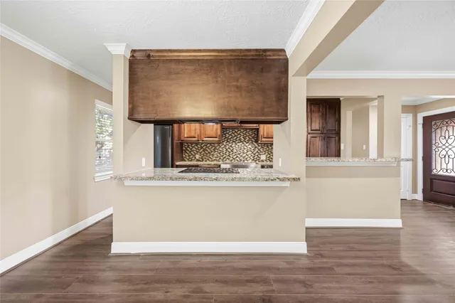 a living room with a wooden floor and a window