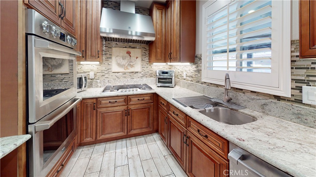 10039 Primrose Drive Riverside, CA 92503 - Photo 14 of 56 a kitchen with a sink stove and cabinets