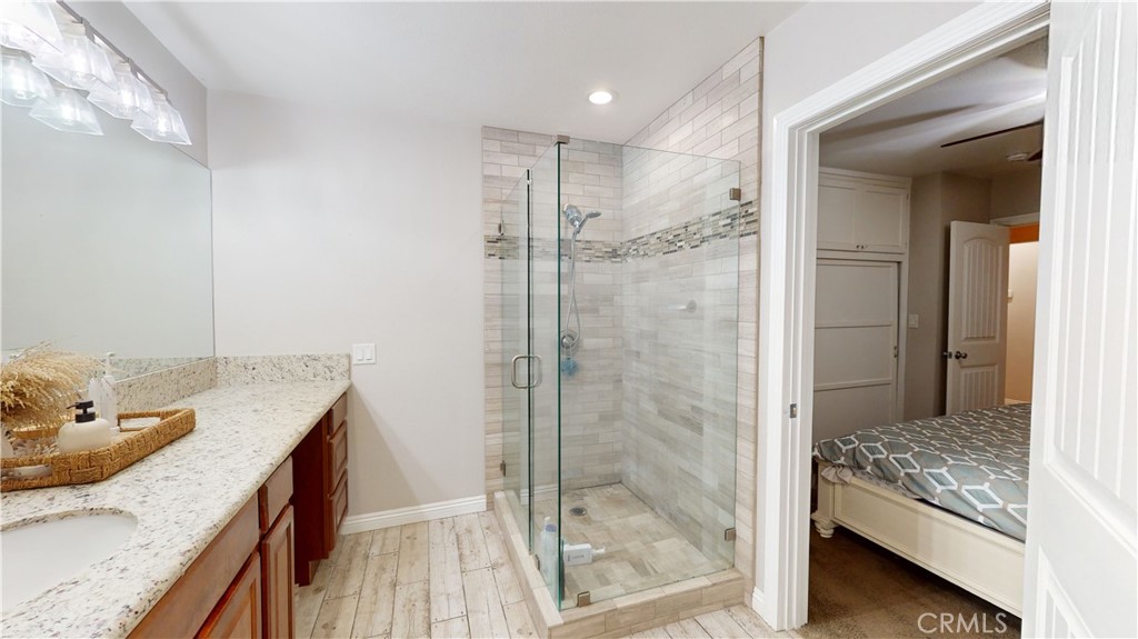 10039 Primrose Drive Riverside, CA 92503 - Photo 19 of 56 a bathroom with a granite countertop sink and a mirror