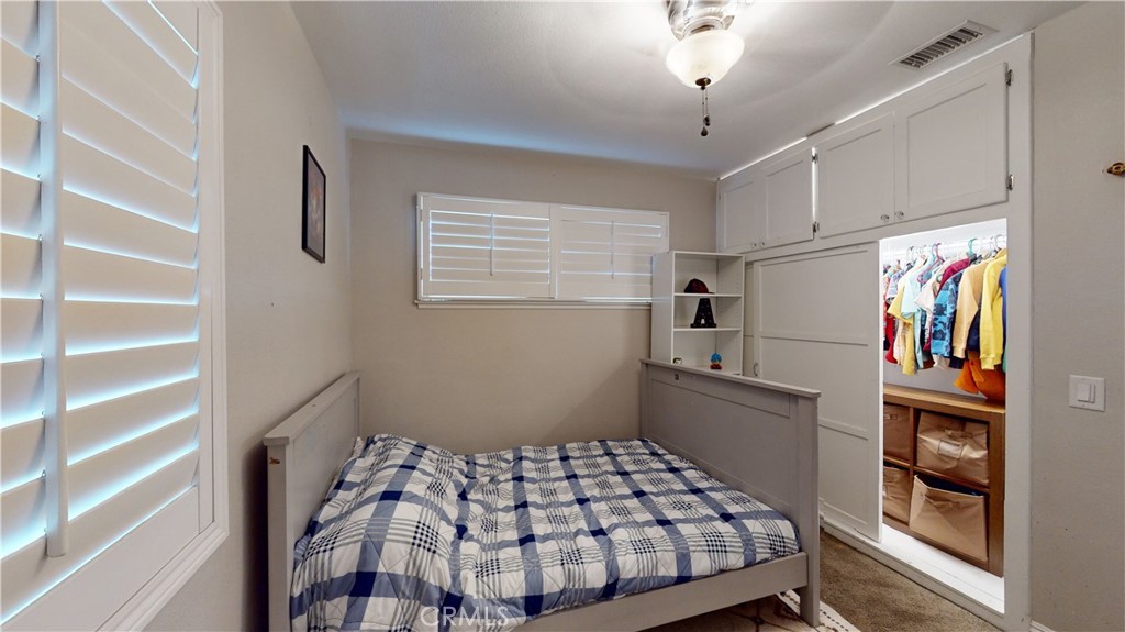10039 Primrose Drive Riverside, CA 92503 - Photo 23 of 56 a bedroom with a bed and a closet