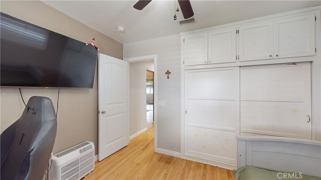 10039 Primrose Drive Riverside, CA 92503 - Photo 27 of 56 a view of a livingroom with wooden floor and cabinet