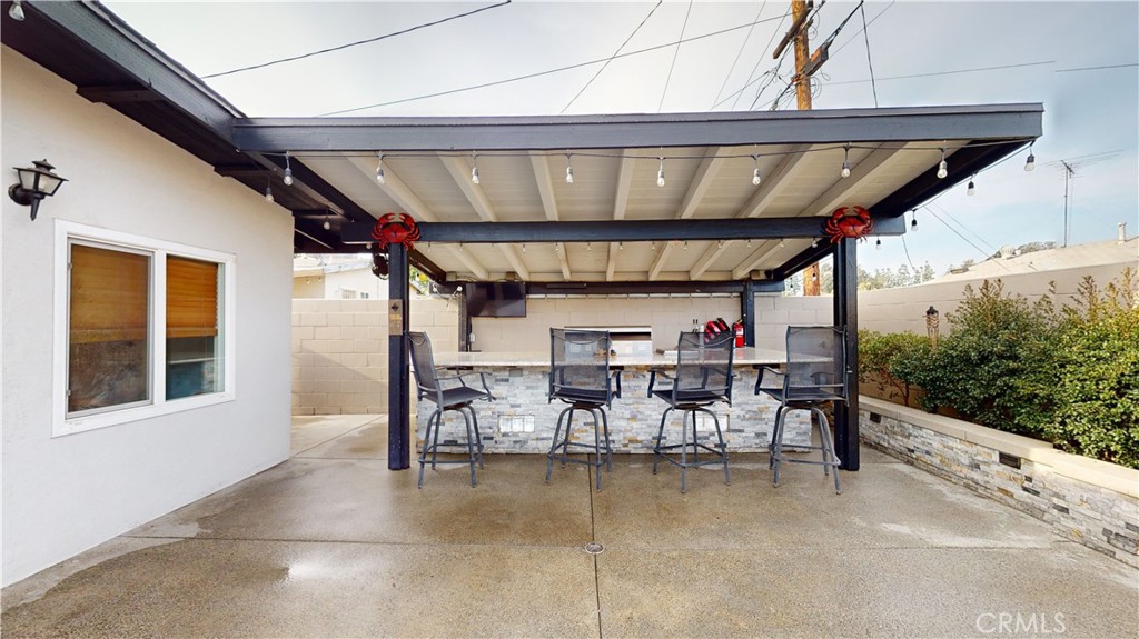 10039 Primrose Drive Riverside, CA 92503 - Photo 37 of 56 a view of a chairs and table in patio with a wooden fence