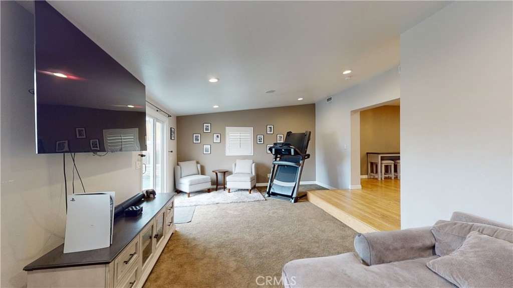 10039 Primrose Drive Riverside, CA 92503 - Photo 4 of 56 a living room with furniture gym equipment and a flat screen tv