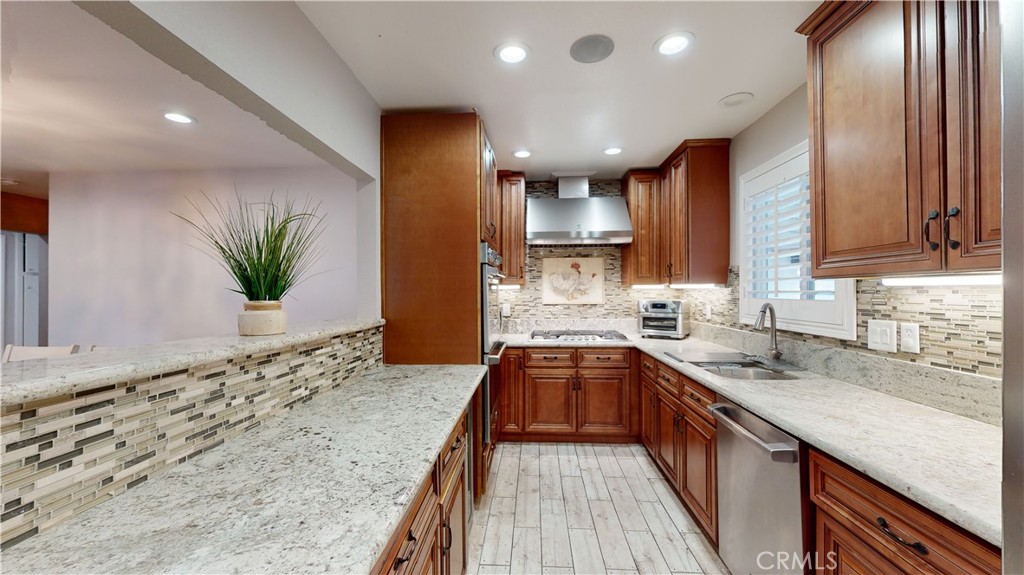 10039 Primrose Drive Riverside, CA 92503 - Photo 8 of 56 a kitchen with stainless steel appliances granite countertop sink stove and cabinets