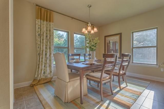 102 Wayne Trail Santa Rosa Beach, FL 32459 - Photo 22 of 31 a view of a dining room with furniture wooden floor and chandelier
