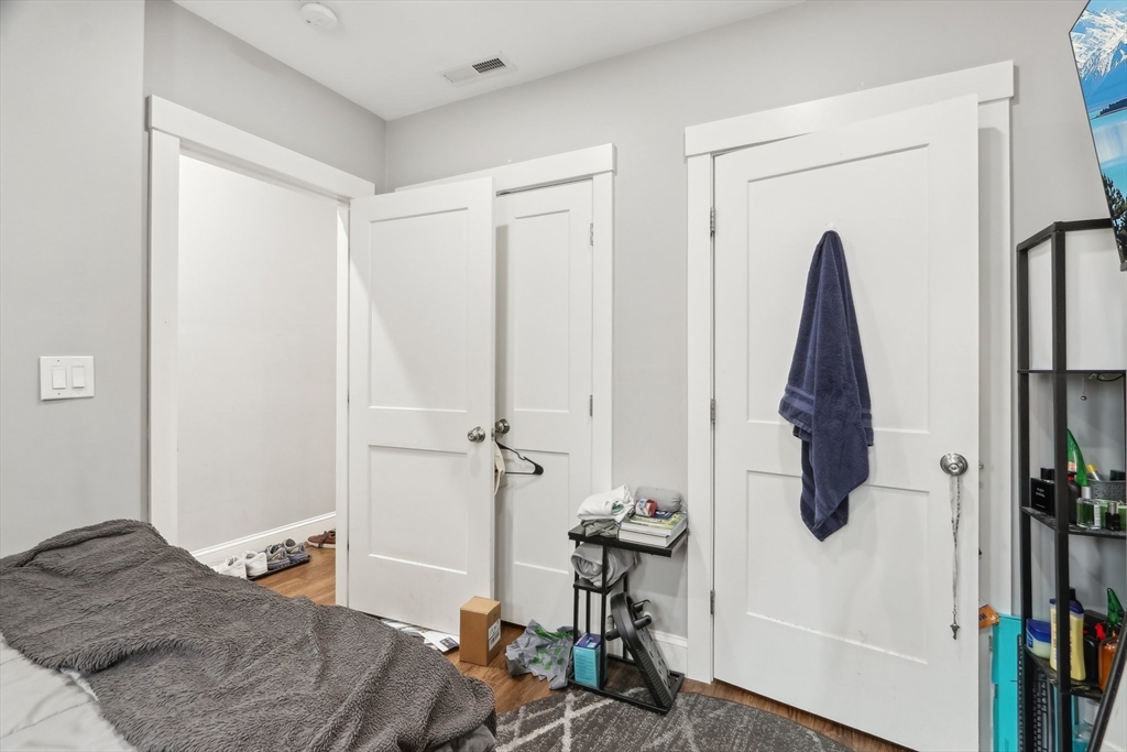 271 West Fifth Street Boston, MA 02127 - Photo 14 of 30 a bedroom with a bed and wooden floor