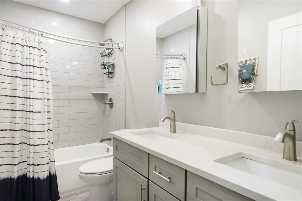 271 West Fifth Street Boston, MA 02127 - Photo 16 of 30 a bathroom with a sink a toilet and shower