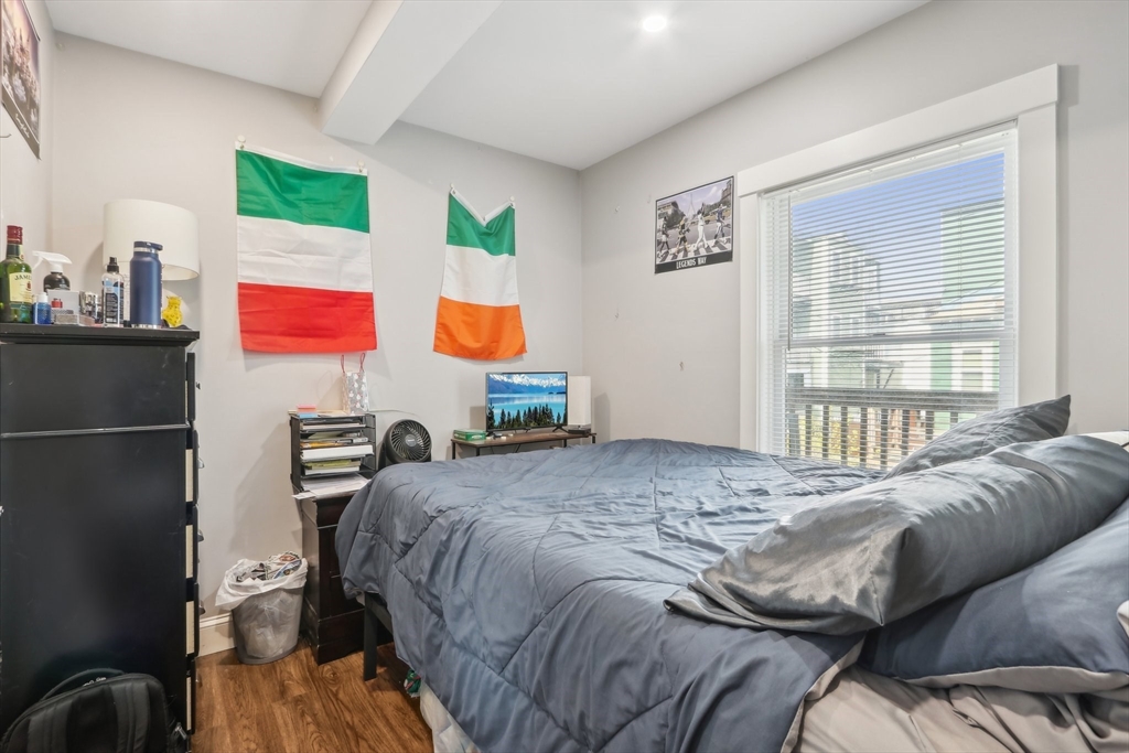 271 West Fifth Street Boston, MA 02127 - Photo 19 of 30 a bedroom with a bed and wooden floor