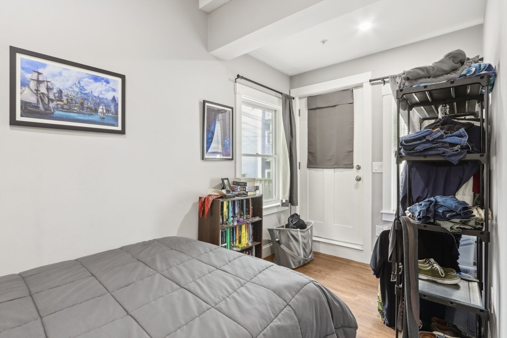271 West Fifth Street Boston, MA 02127 - Photo 21 of 30 a bedroom with a bed and a mirror