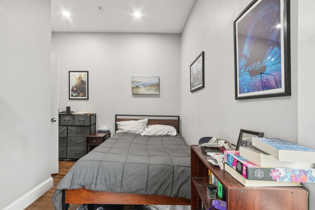 271 West Fifth Street Boston, MA 02127 - Photo 22 of 30 a bedroom with a bed and wooden floor