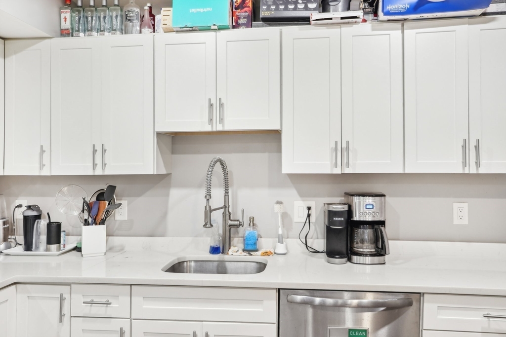 271 West Fifth Street Boston, MA 02127 - Photo 5 of 30 a kitchen with white cabinets and sink