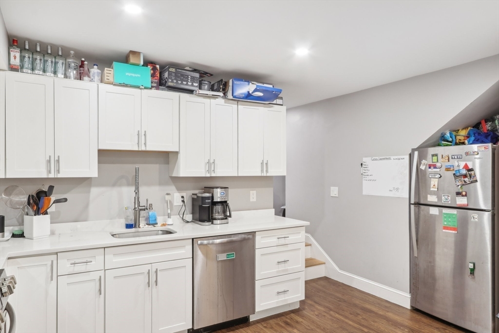 271 West Fifth Street Boston, MA 02127 - Photo 6 of 30 a kitchen with stainless steel appliances a refrigerator sink and cabinets