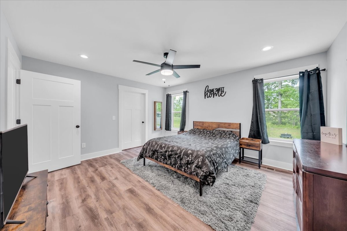 116 Carter Blake Road Tullahoma, TN 37388 - Photo 27 of 43 a spacious bedroom with a bed a table and a chandelier