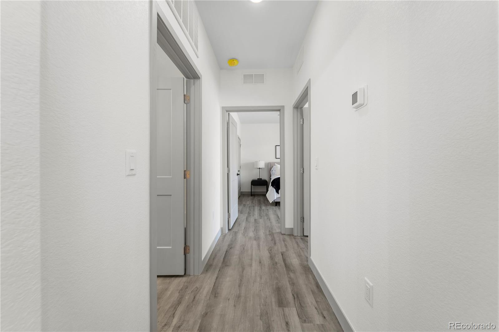 18645 Stroh Road, Unit 103 Parker, CO 80134 - Photo 16 of 32 a view of a hallway with wooden floor