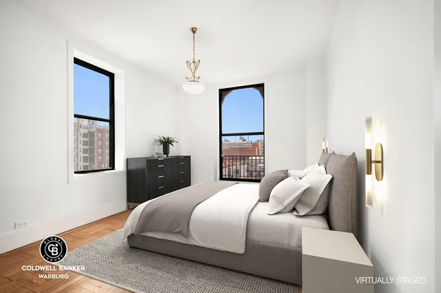 a bedroom with a bed and a mirror