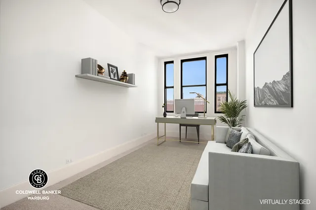 a living room with furniture and a floor to ceiling window