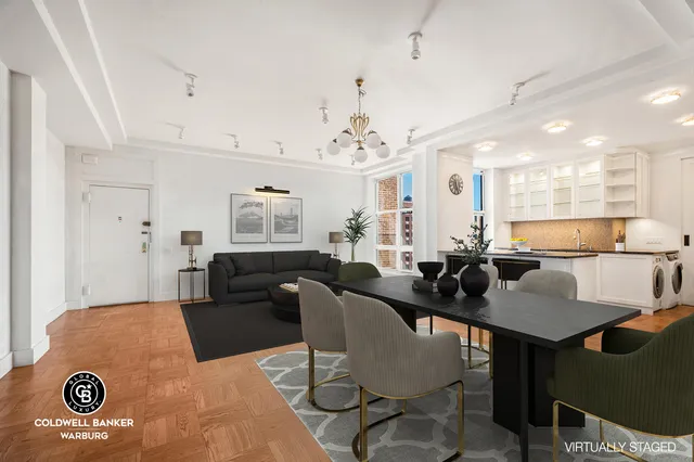 a living room with furniture and a chandelier
