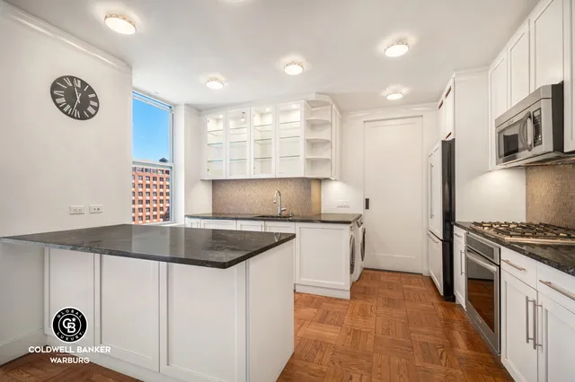 a kitchen with a sink a stove and cabinets