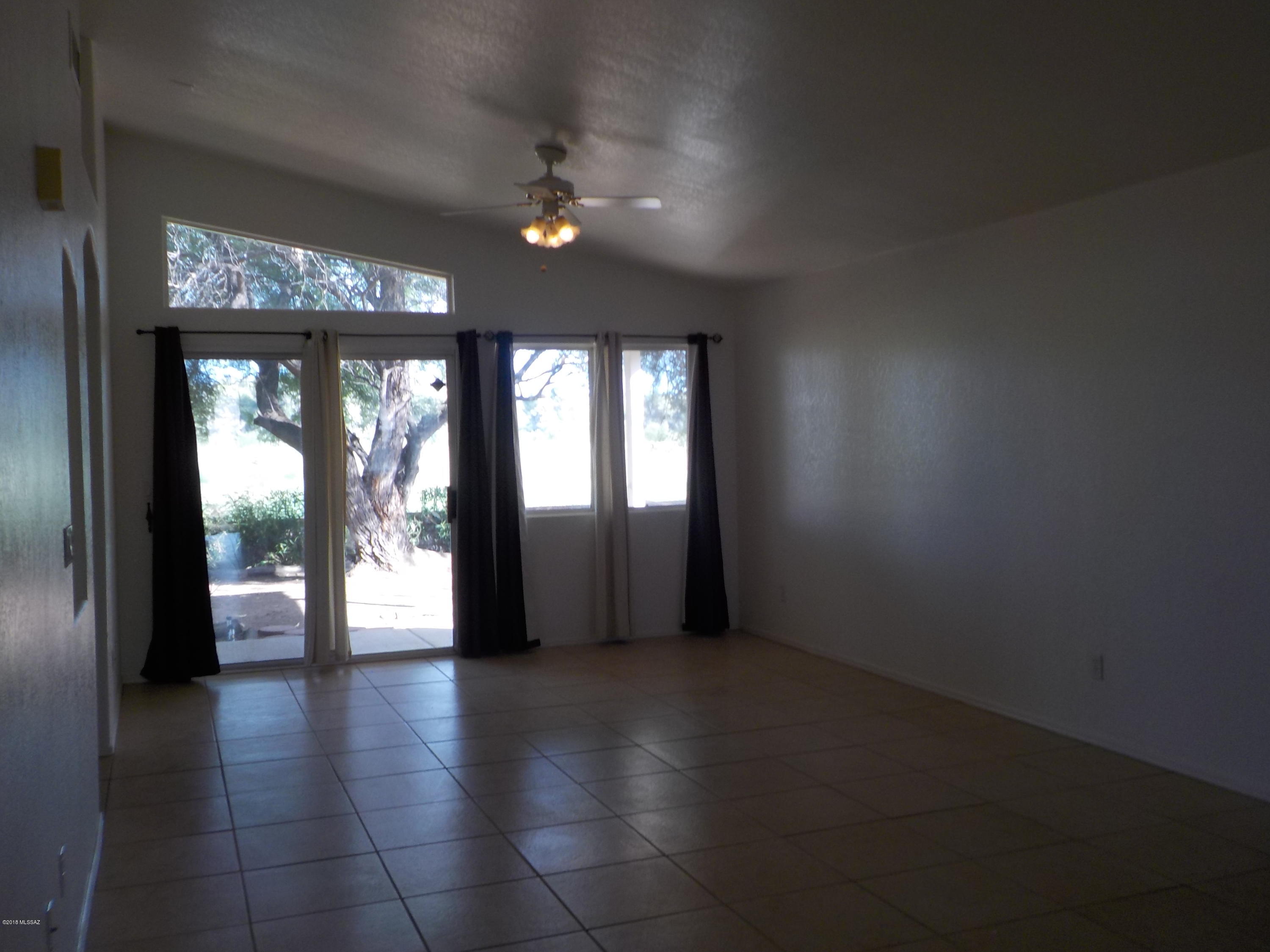 1153 Circulo Canario Rio Rico, AZ 85648 - Photo 7 of 16 wooden floor in an empty room with a window