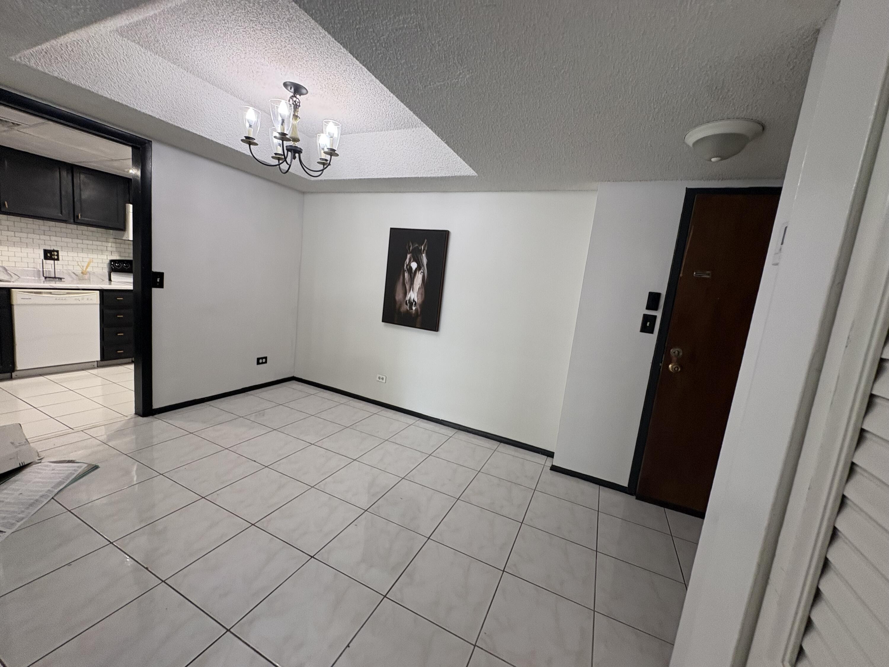 3660 Inverrary Drive, Unit 1B Lauderhill, FL 33319 - Photo 2 of 27 a view of a livingroom with a furniture wooden floor and chandelier